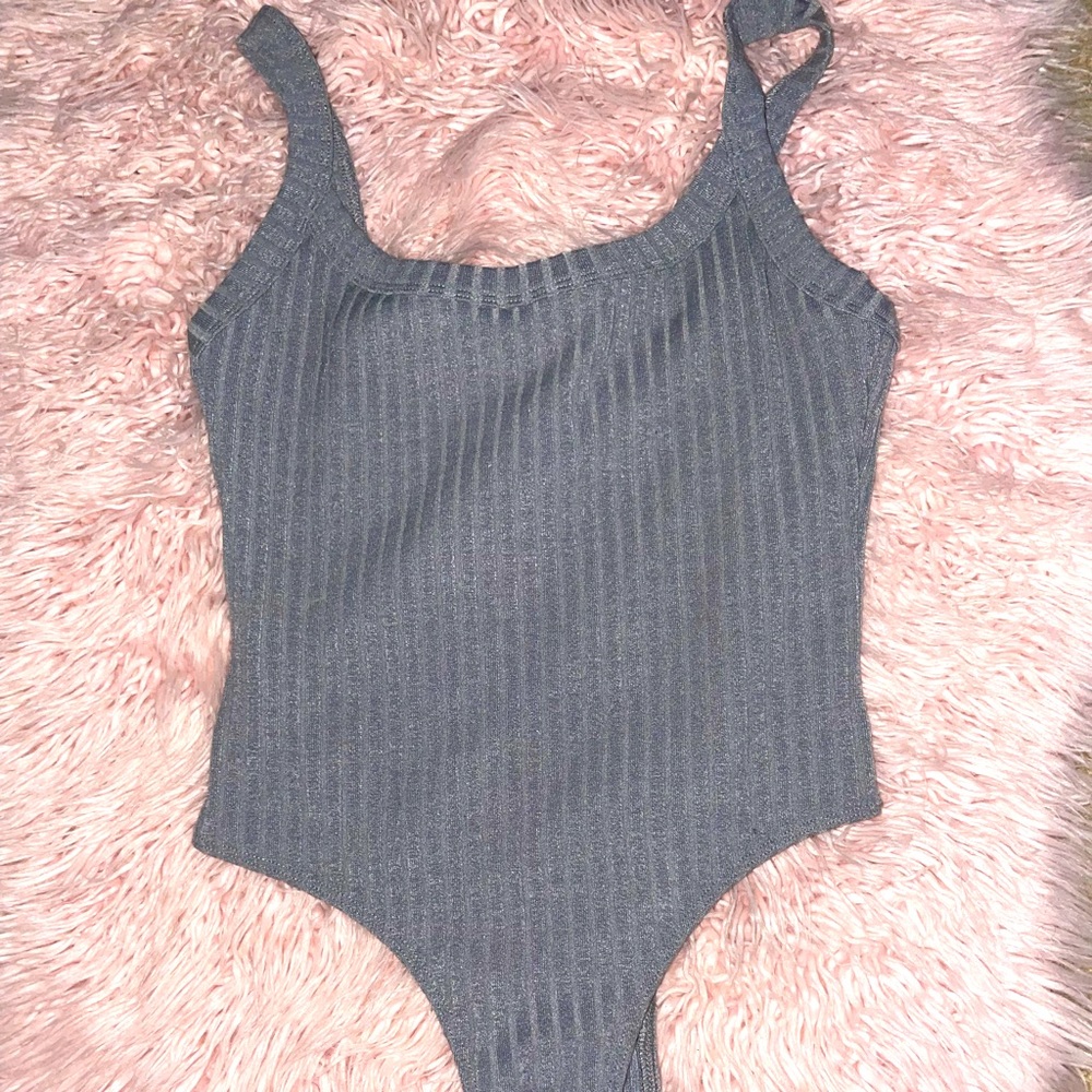grey ribbed bodysuit, hugs body Perfectly , keeps it’s form to the end the night